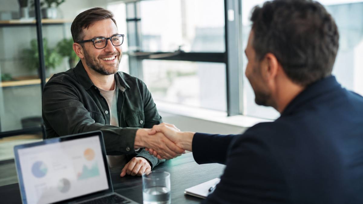 Business partners shaking hands after joining a best affiliate network
